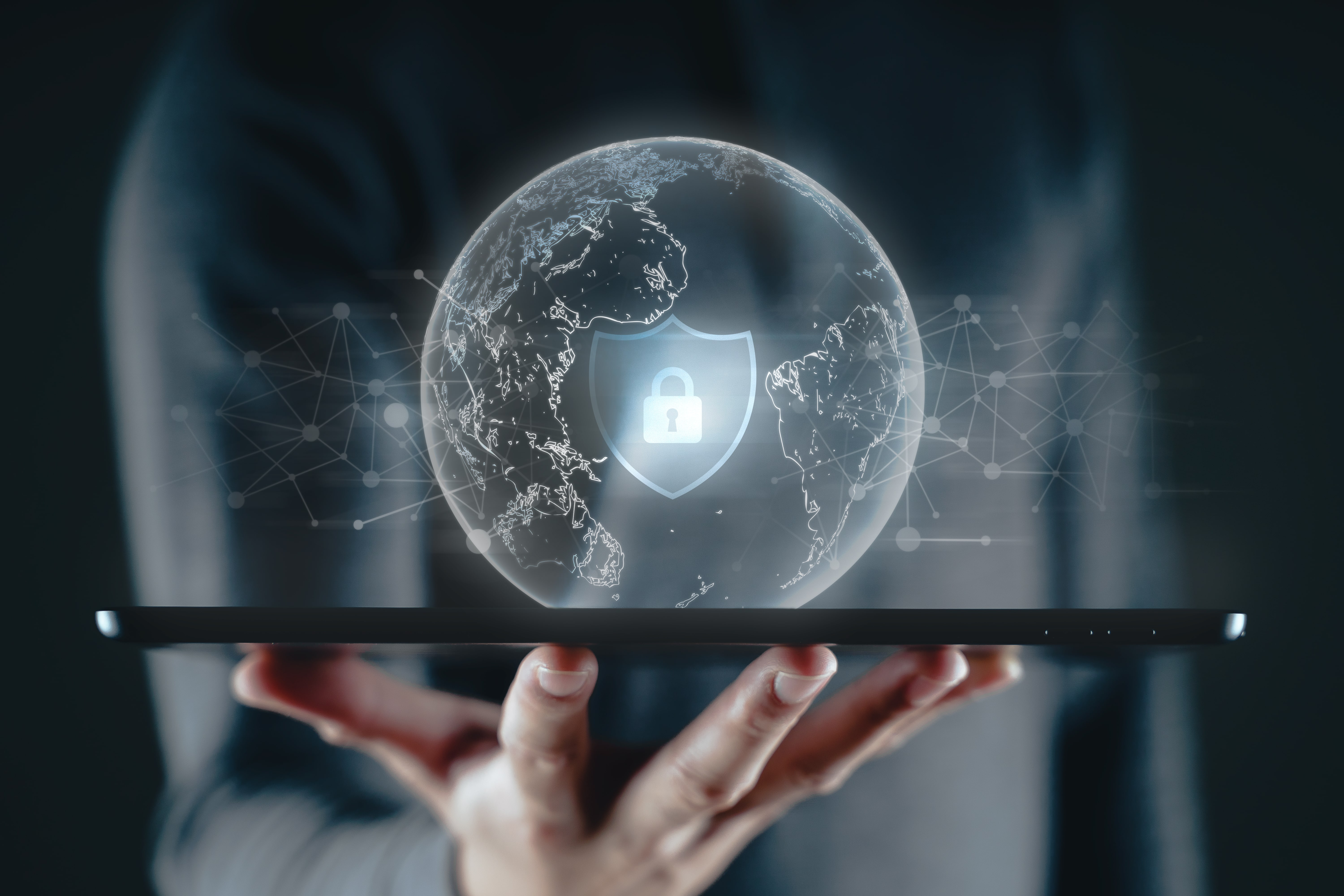 Secure digital globe displayed above a tablet